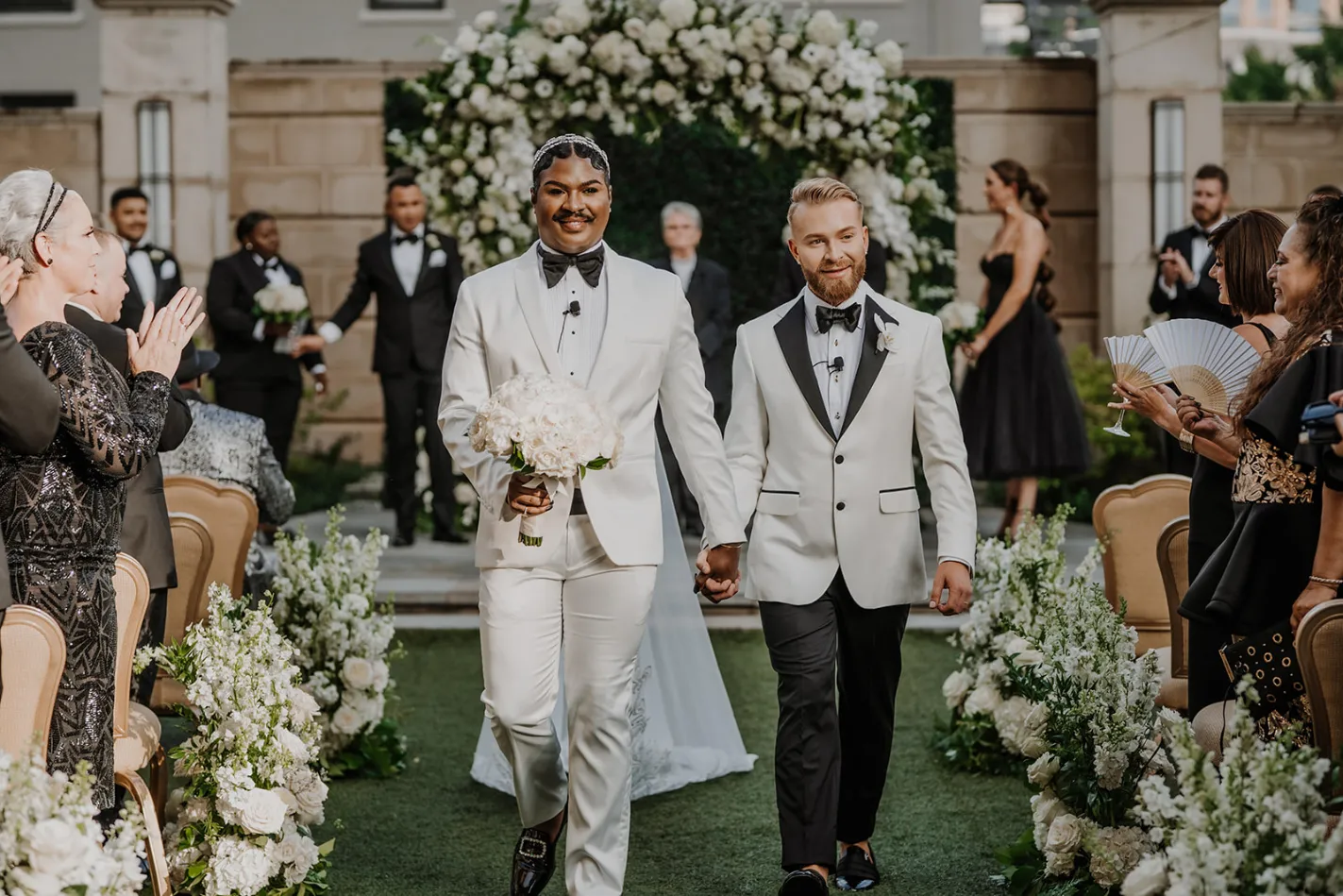 gay couple walking down the aisle as husband and husband